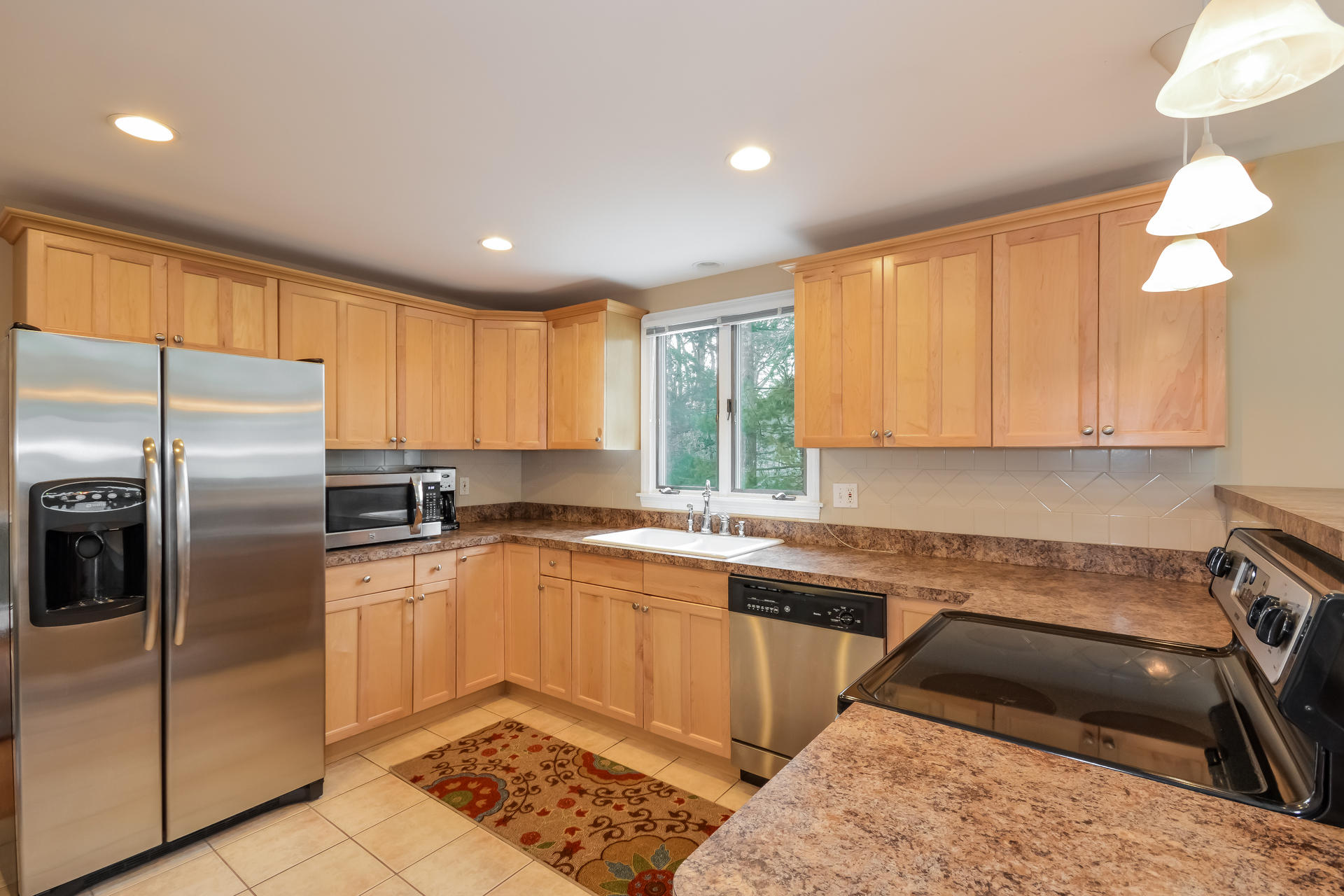 188 Ansel Howland Road Centerville, MA 02632 - Photo 9 of 24 a kitchen with a sink a counter top space cabinets and stainless steel appliances