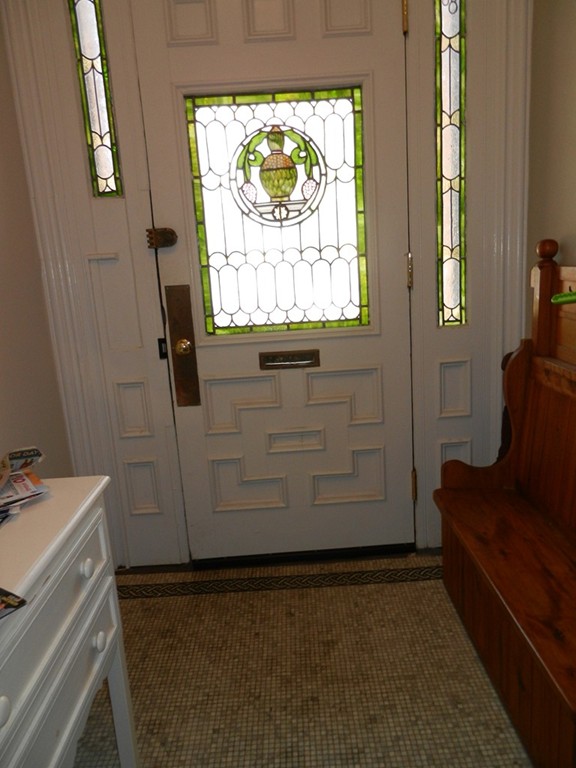 80 Rutland Street, Unit 3 Boston, MA 02118 - Photo 22 of 26 a living room with a couch and a dresser next to a window