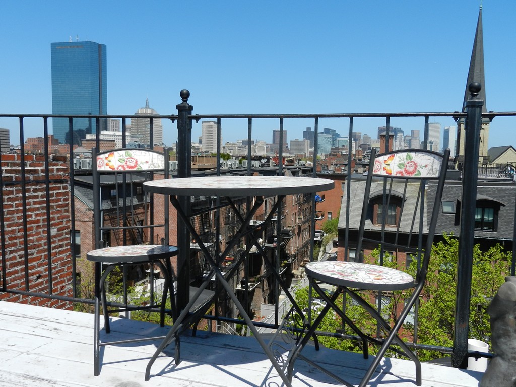 80 Rutland Street, Unit 3 Boston, MA 02118 - Photo 26 of 26 a table and chairs in front of a house