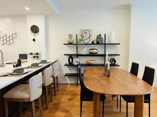 a dining room with furniture and wooden floor