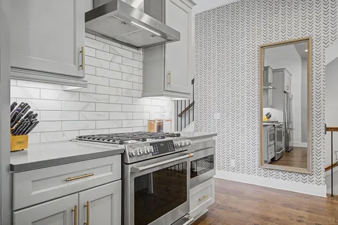 a kitchen with stainless steel appliances granite countertop a stove and a sink