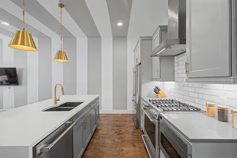 a kitchen that has a sink and a stove