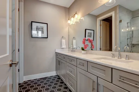a bathroom with a double vanity sink and a mirror
