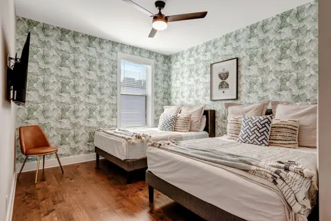 a bedroom with a bed and a chair