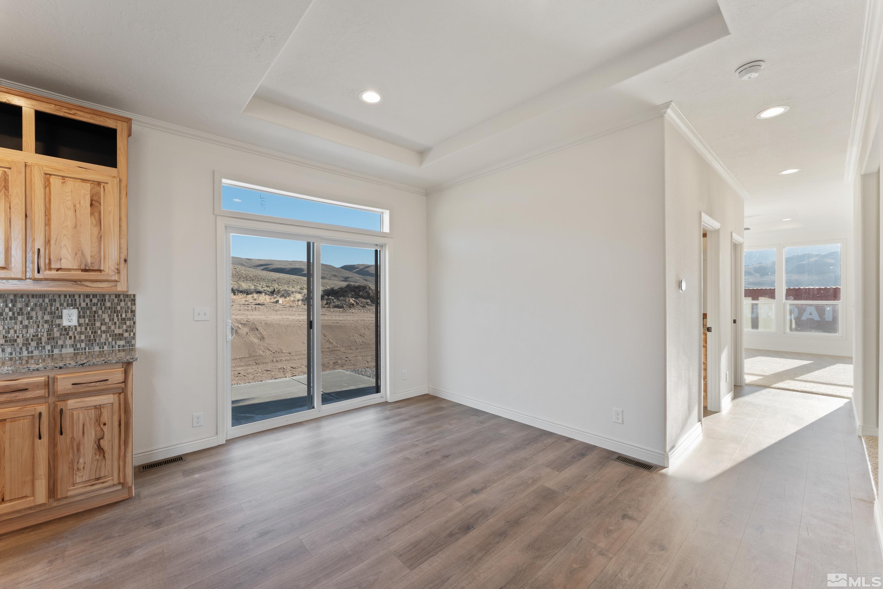 90 Horseshoe Circle Reno, NV 89508 - Photo 13 of 40 an empty room with wooden floor and a bathroom