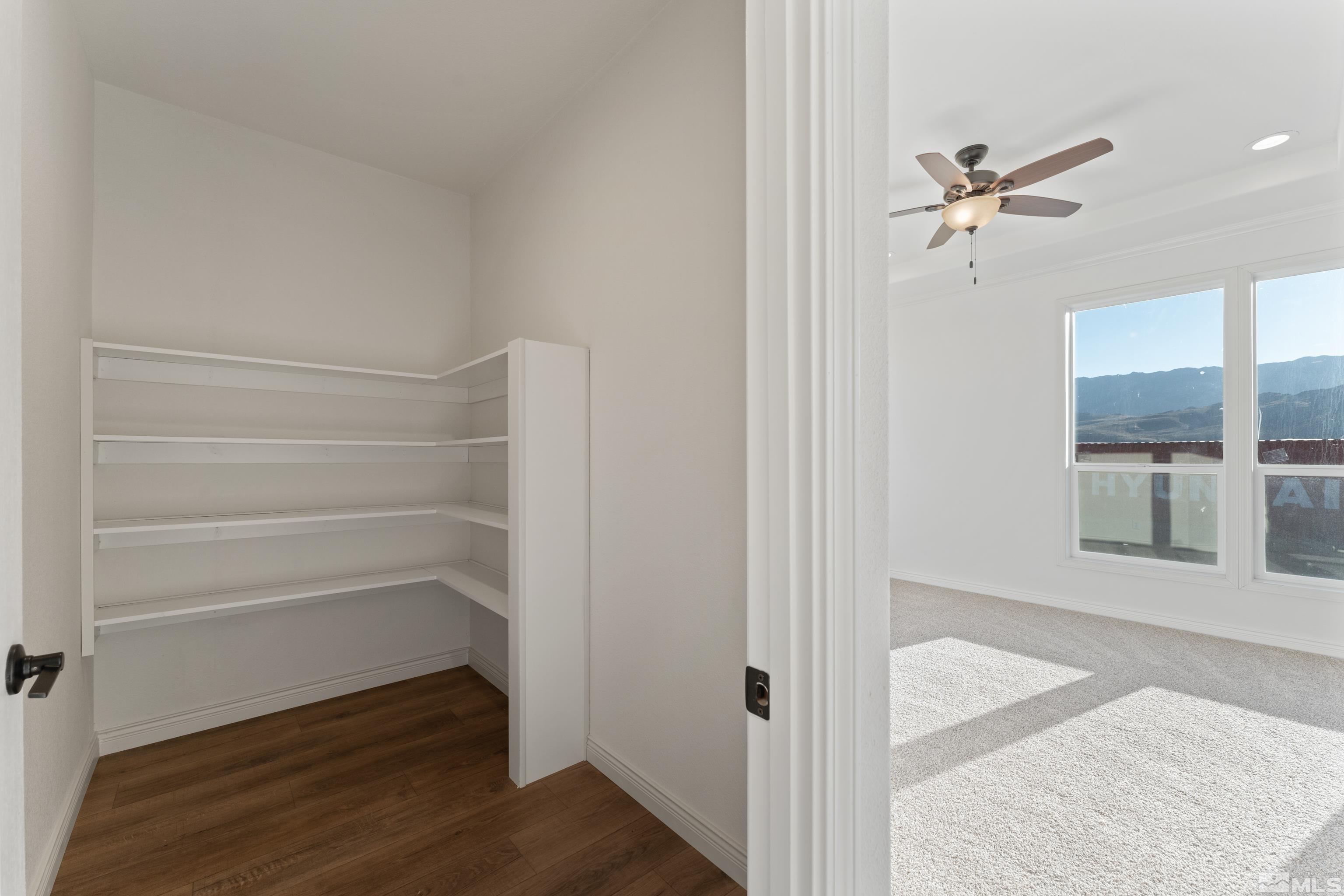90 Horseshoe Circle Reno, NV 89508 - Photo 17 of 40 a view of a hallway with wooden floor and a cabinet