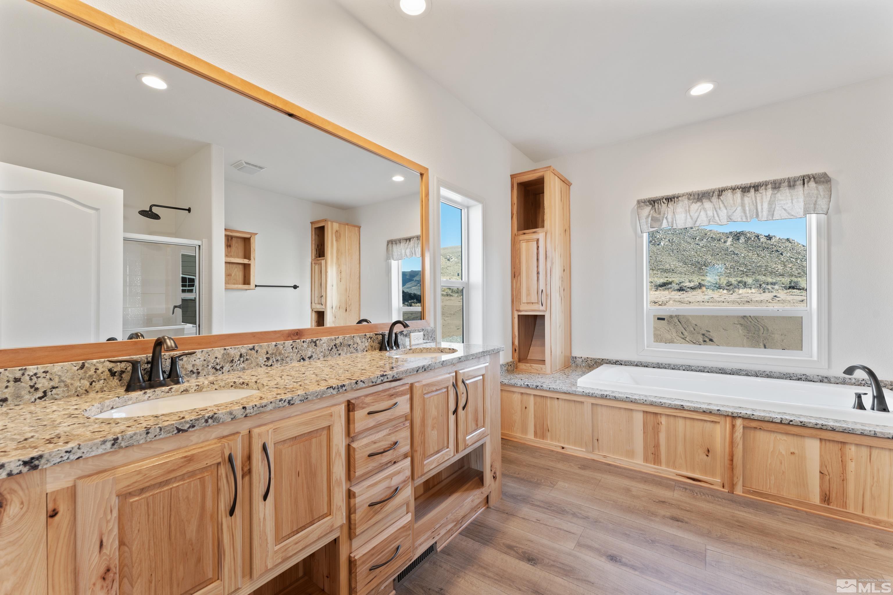 90 Horseshoe Circle Reno, NV 89508 - Photo 25 of 40 a bathroom with a granite countertop double vanity sink a mirror and a bathtub
