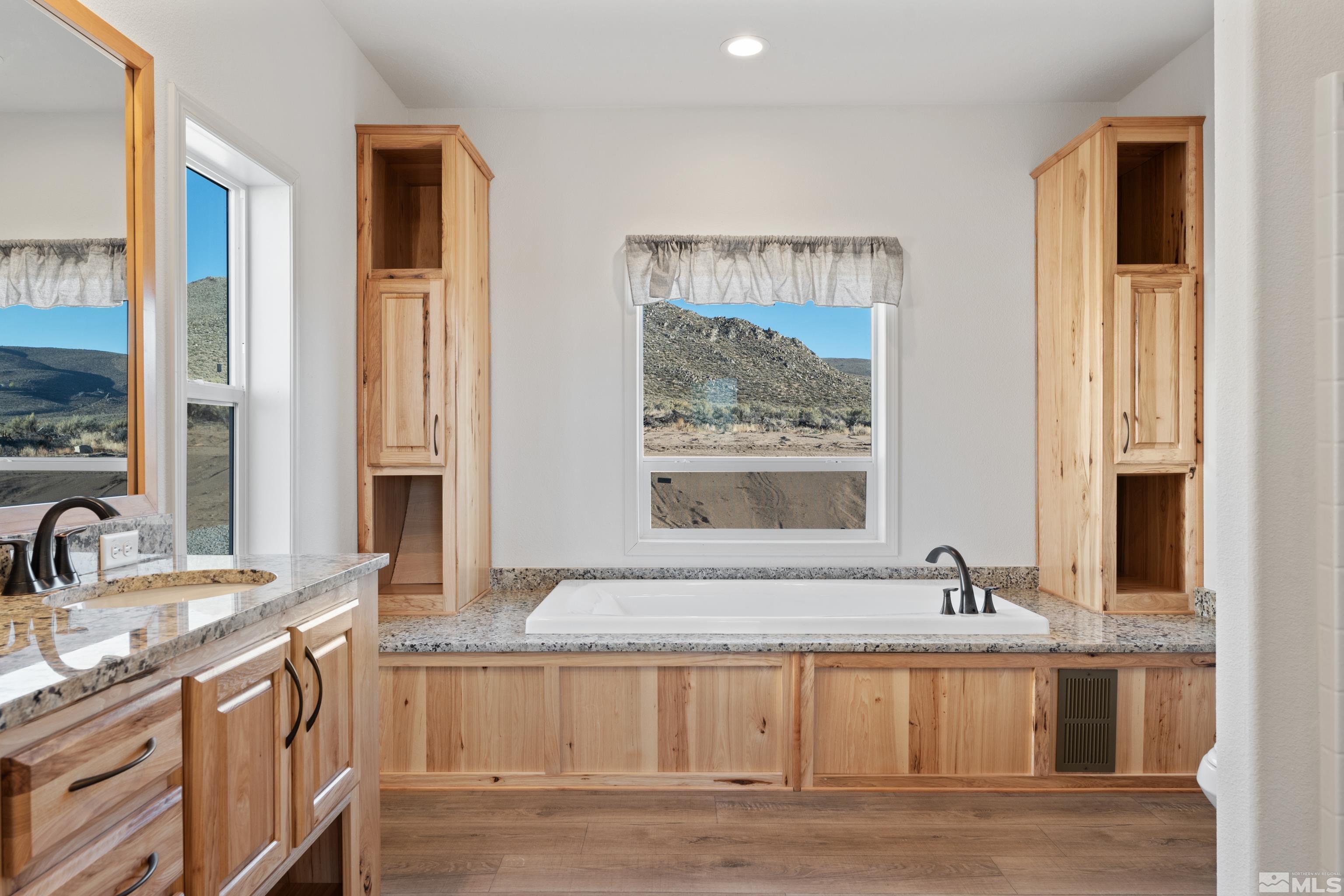 90 Horseshoe Circle Reno, NV 89508 - Photo 26 of 40 a view of a bathroom with granite countertop a sink and a window