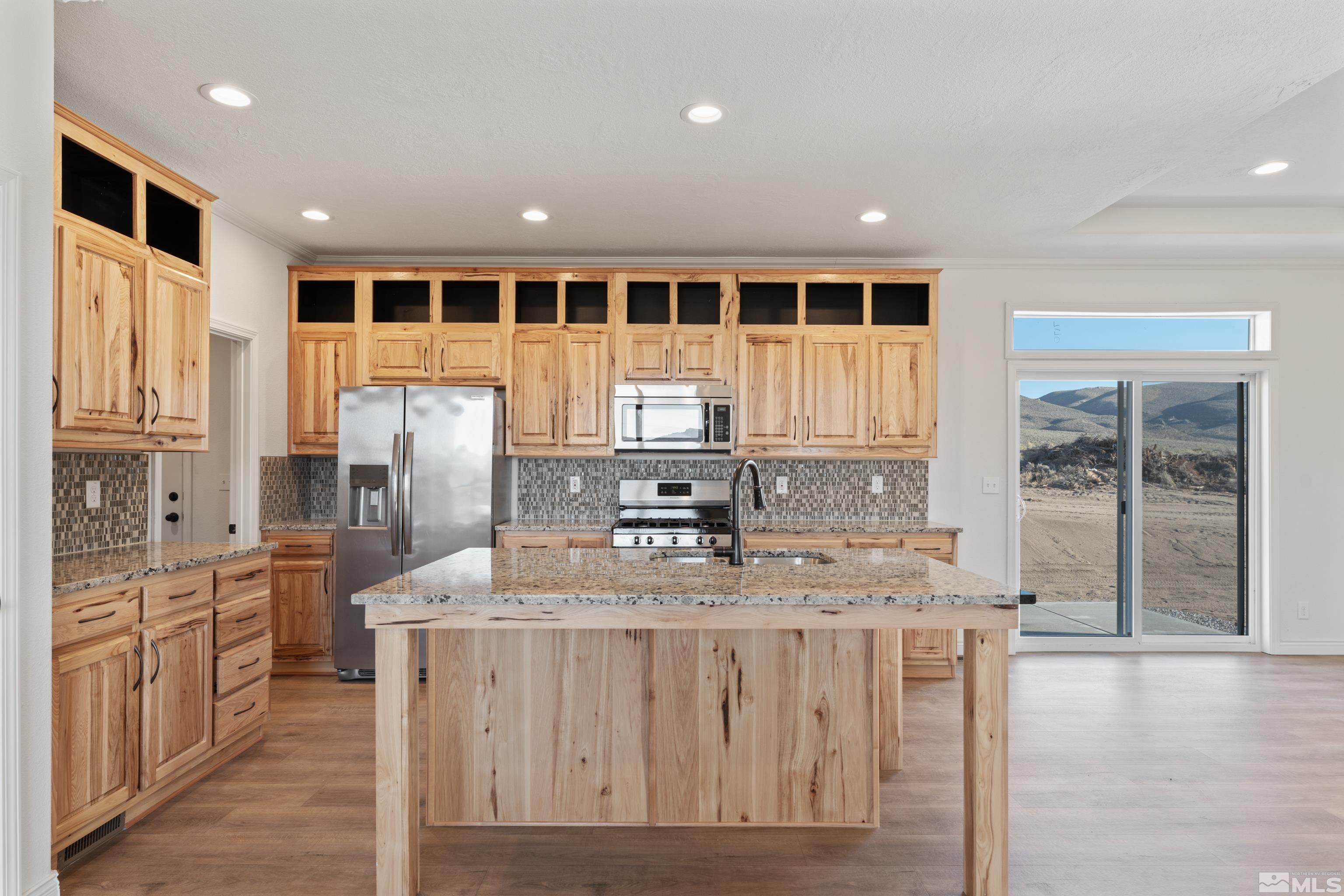90 Horseshoe Circle Reno, NV 89508 - Photo 4 of 40 a kitchen with stainless steel appliances granite countertop a stove and a refrigerator