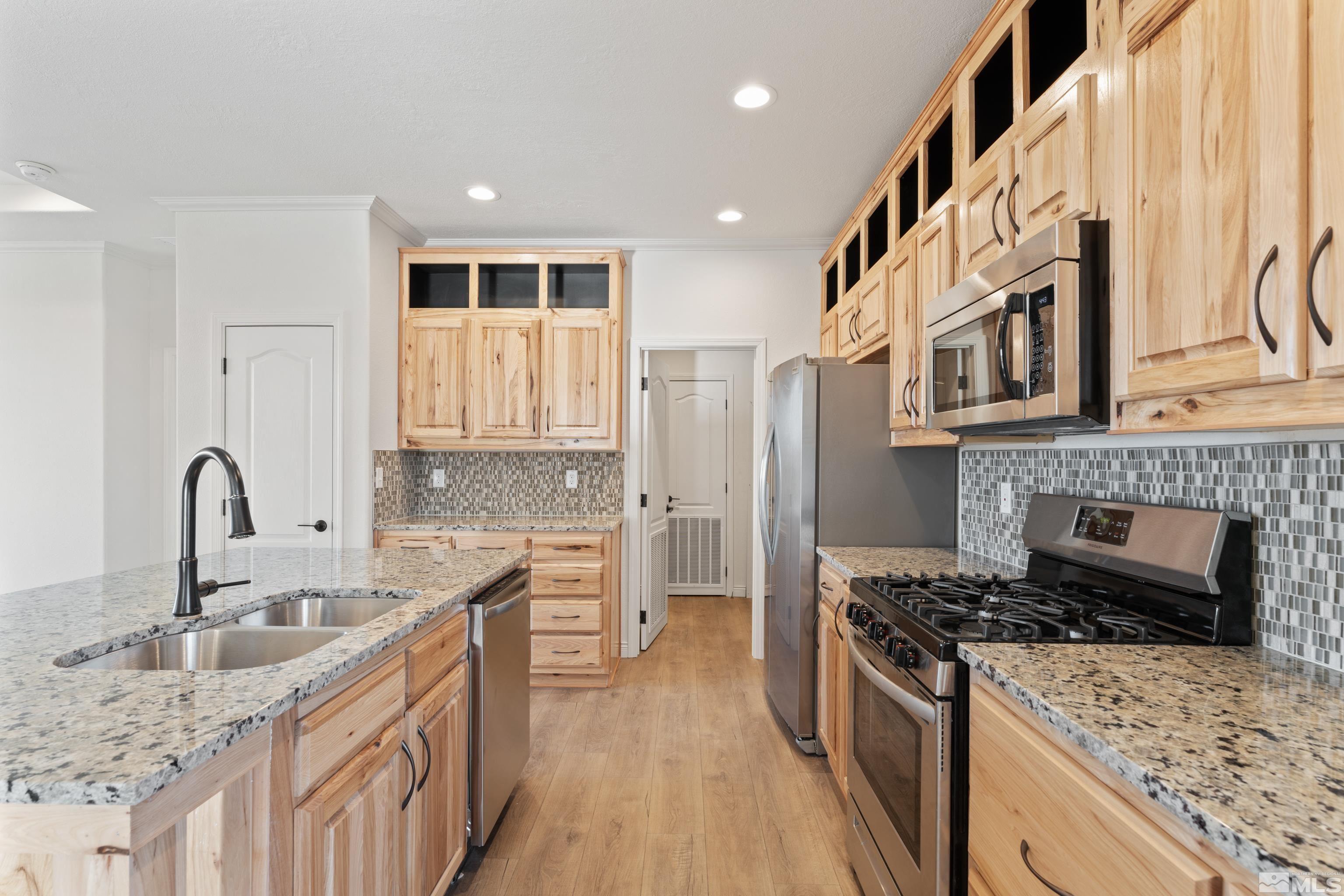 90 Horseshoe Circle Reno, NV 89508 - Photo 5 of 40 a kitchen with stainless steel appliances granite countertop a stove and a sink