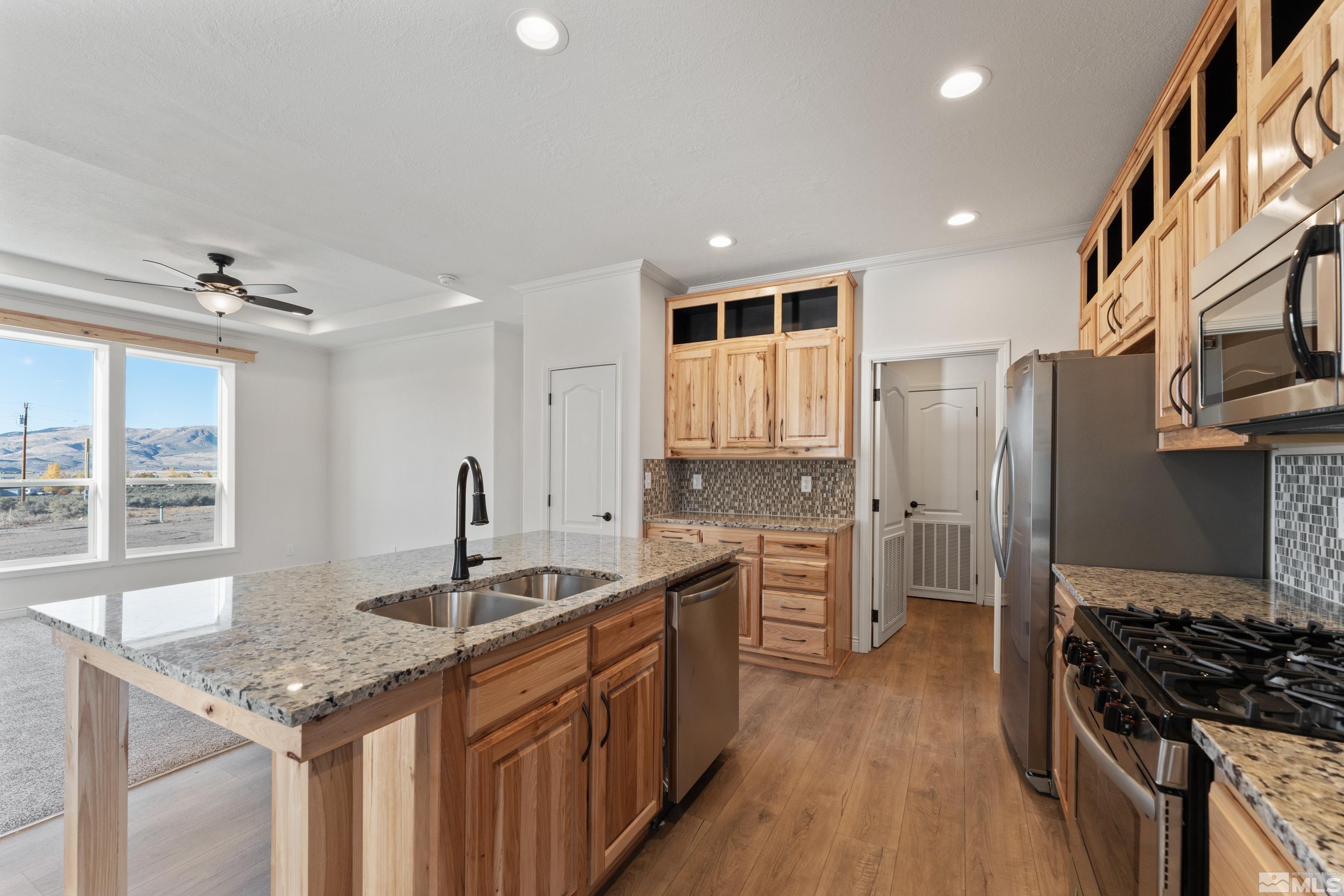 90 Horseshoe Circle Reno, NV 89508 - Photo 6 of 40 a kitchen with stainless steel appliances granite countertop a sink stove and refrigerator