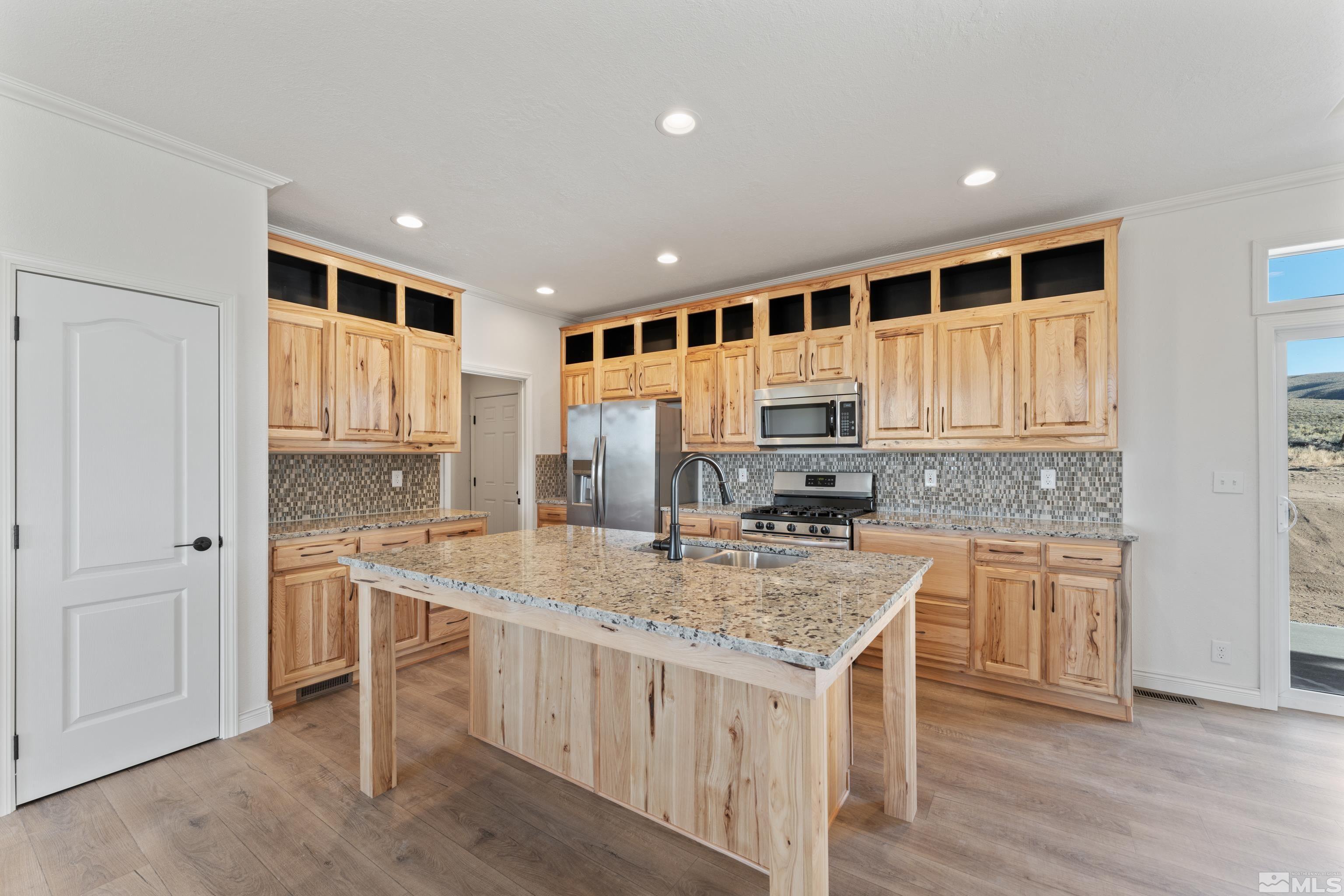 90 Horseshoe Circle Reno, NV 89508 - Photo 7 of 40 a kitchen with a stove a sink and a refrigerator