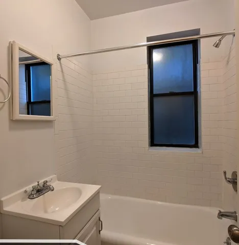 a bathroom with a shower and a sink