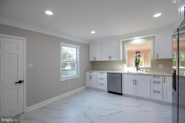 a kitchen with stainless steel appliances granite countertop a refrigerator and a sink