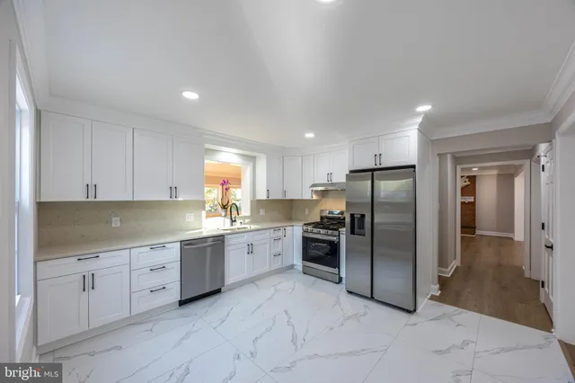 a kitchen with cabinets appliances and a window