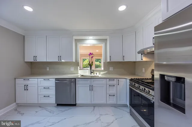 a kitchen with cabinets and a stove top oven