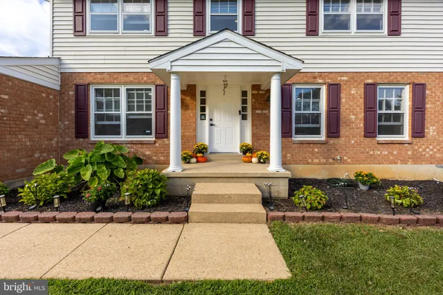 a front view of a house with a yard and outdoor seating