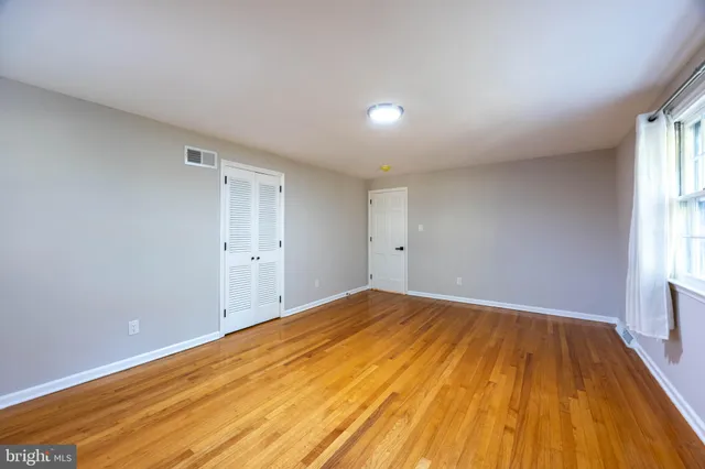 a view of a bedroom with wooden floor and bedroom