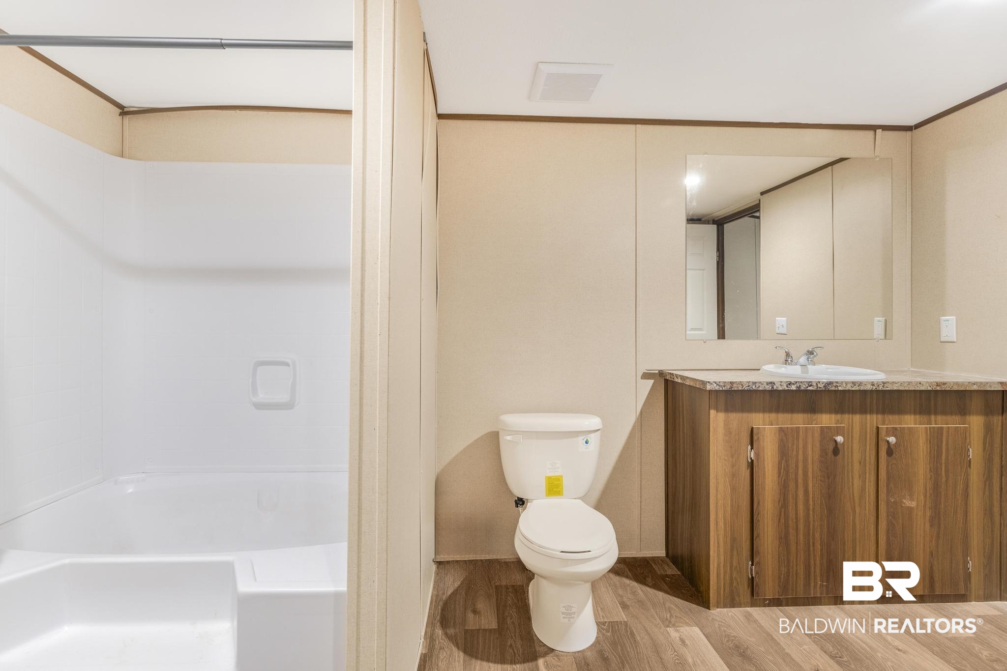 54309 Klasnich Road Perdido, AL 36562 - Photo 23 of 29 Bathroom featuring vanity, light wood-style floors, and tub / shower combination