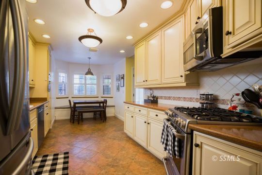 1209 Jennifer Court Ridgecrest, CA 93555 - Photo 9 of 33 a kitchen with stainless steel appliances granite countertop a stove a sink and a refrigerator