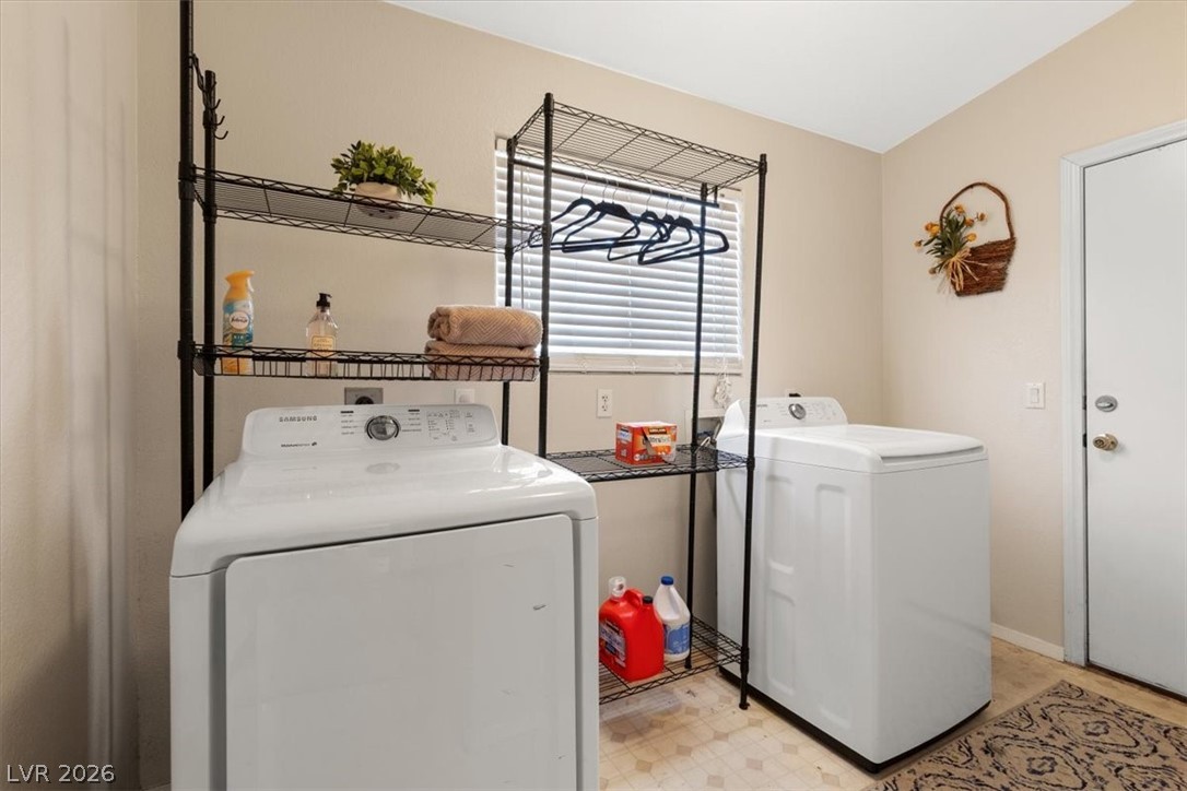 2377 Ramsgate Drive Henderson, NV 89074 - Photo 21 of 25 A dedicated laundry room provides convenience with a washer, dryer, and storage shelving.