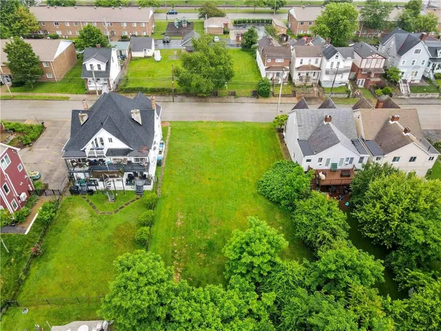an aerial view of a house with garden space and street view