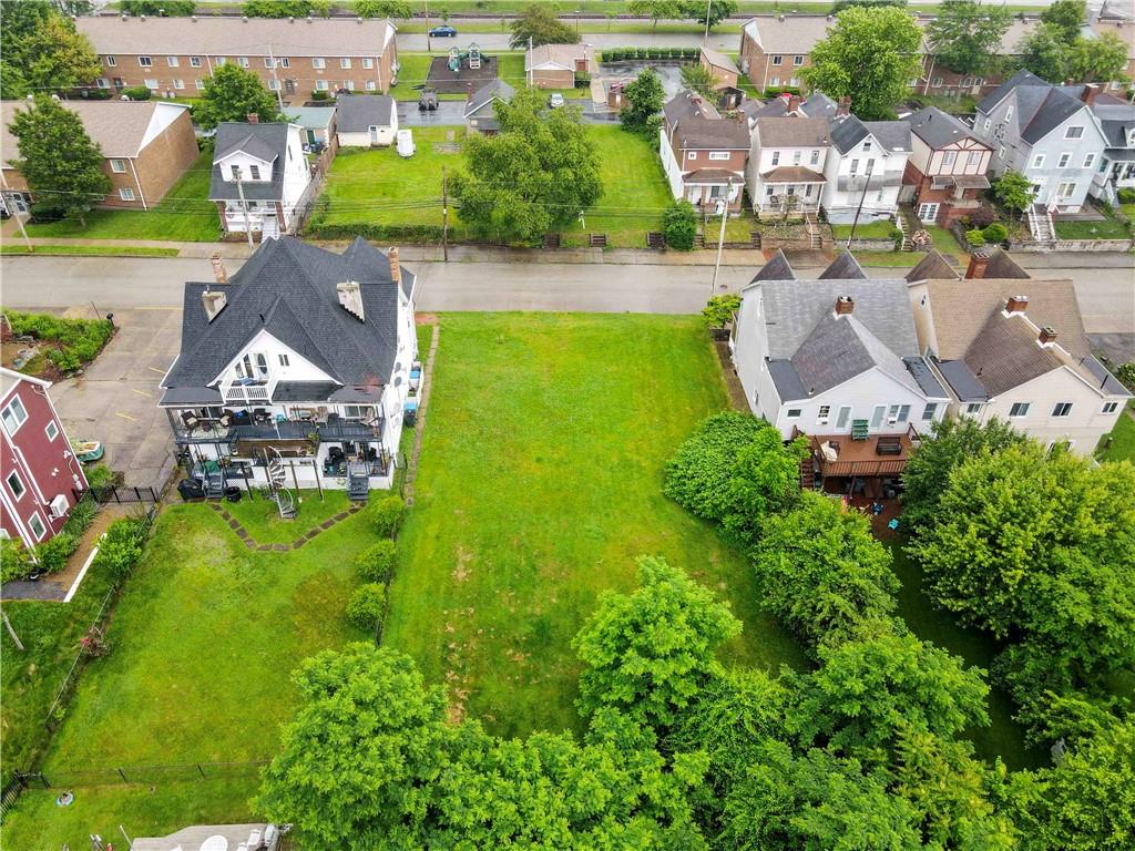 an aerial view of a house with garden space and street view