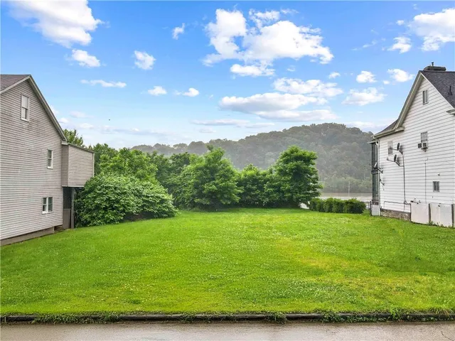 an aerial view of residential houses with yard