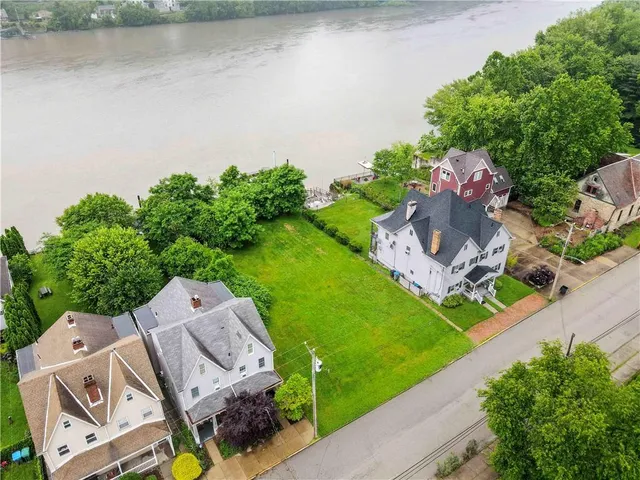 an aerial view of a house with a lake view