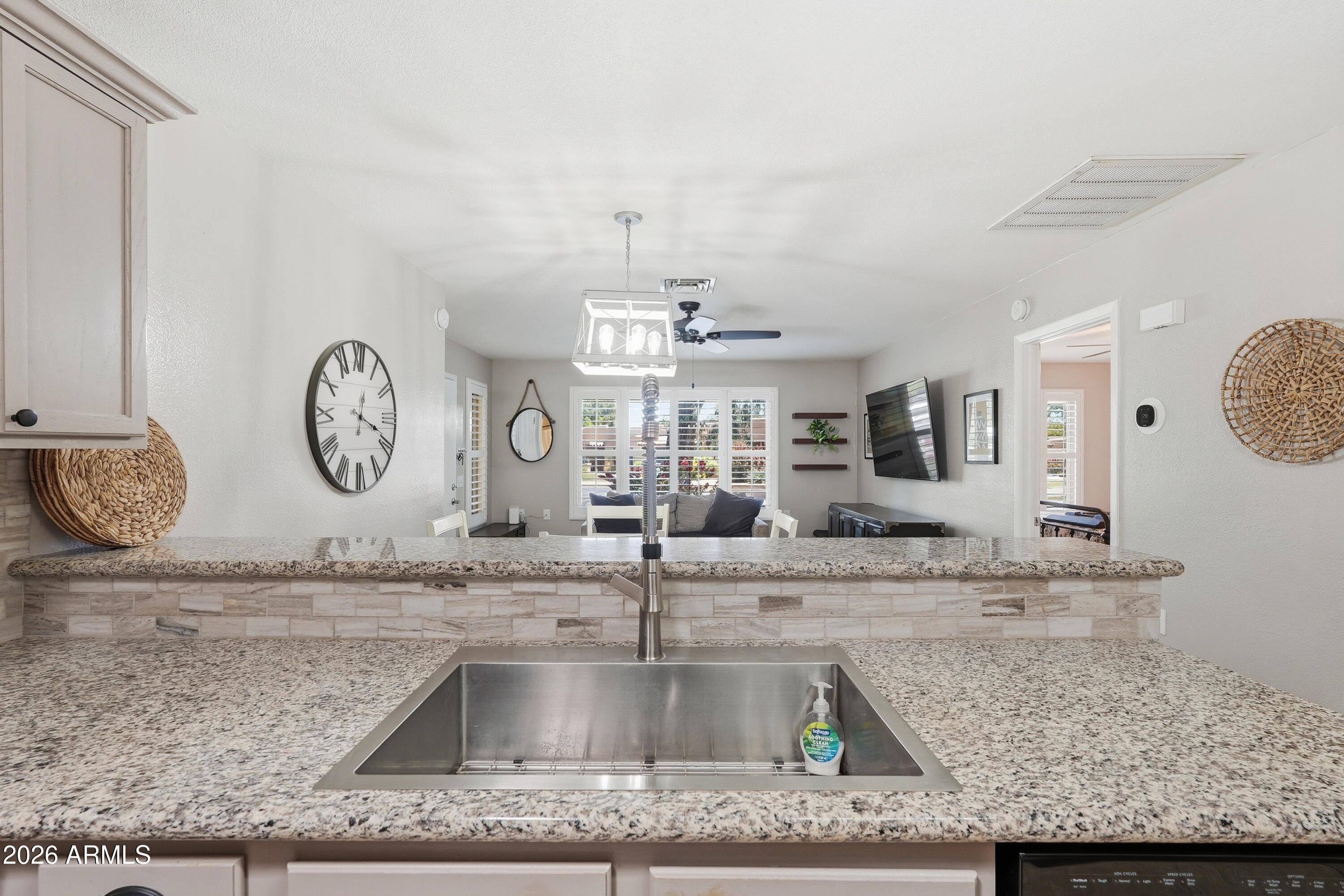 14300 West Bell Road, Unit 49 Surprise, AZ 85374 - Photo 6 of 19 a view with a faucet a sink and a clock on top