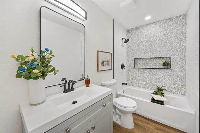 a bathroom with a toilet a sink and a mirror