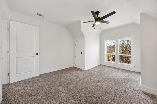 a view of an empty room with a ceiling fan