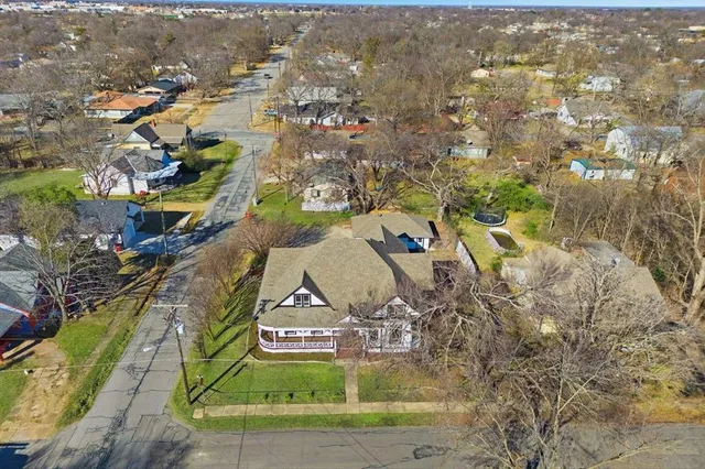 an aerial view of residential houses with outdoor space