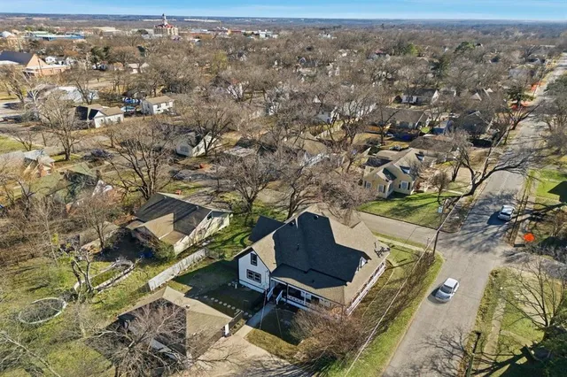 an aerial view of residential houses with outdoor space