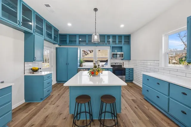 a kitchen with a wooden floor and furniture