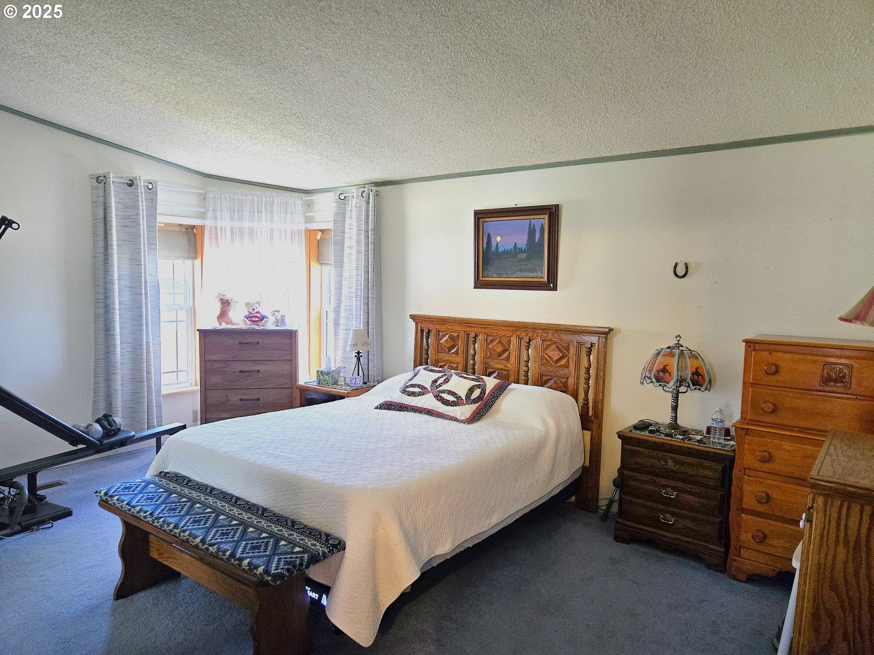 401 Main Street Unity, OR 97884 - Photo 12 of 46 a bedroom with a bed and a dresser in it