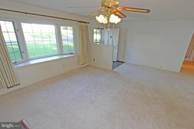 5648 Inverchapel Road Springfield, VA 22151 - Photo 10 of 30 en empty room with windows and chandelier