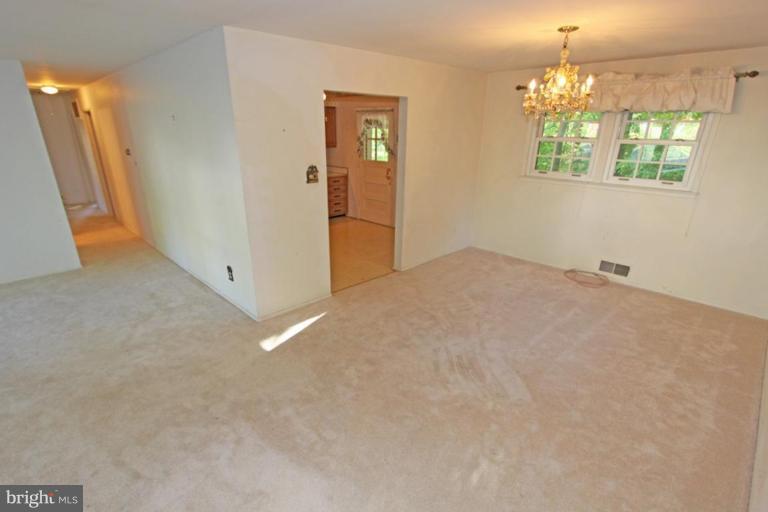 5648 Inverchapel Road Springfield, VA 22151 - Photo 11 of 30 an empty room with windows and chandelier
