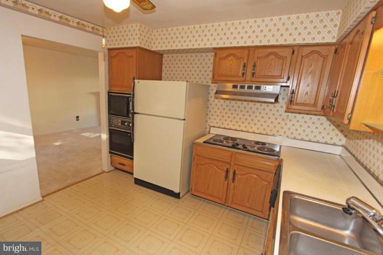 5648 Inverchapel Road Springfield, VA 22151 - Photo 15 of 30 a kitchen with a stove a refrigerator and a sink