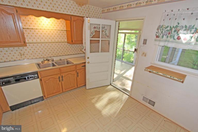5648 Inverchapel Road Springfield, VA 22151 - Photo 16 of 30 a view of a kitchen with a sink dishwasher and wooden floor