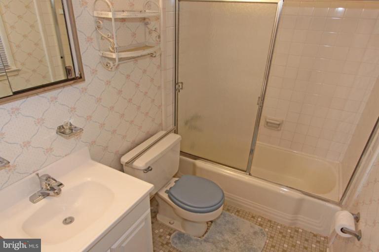 5648 Inverchapel Road Springfield, VA 22151 - Photo 21 of 30 a bathroom with a sink a toilet and shower
