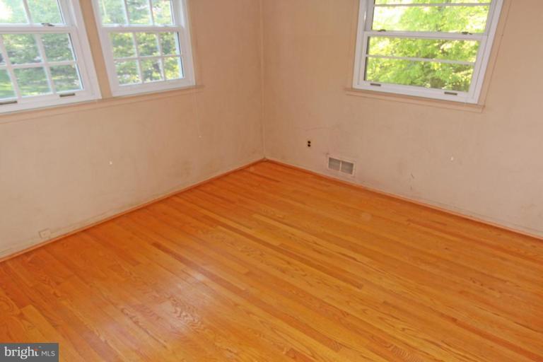 5648 Inverchapel Road Springfield, VA 22151 - Photo 22 of 30 an empty room with wooden floor and windows