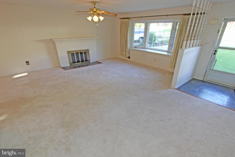 5648 Inverchapel Road Springfield, VA 22151 - Photo 7 of 30 an empty room with windows and chandelier