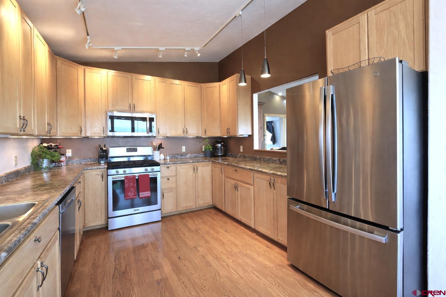 21976 2225th Road Cedaredge, CO 81413 - Photo 7 of 36 a kitchen with stainless steel appliances a refrigerator sink and microwave