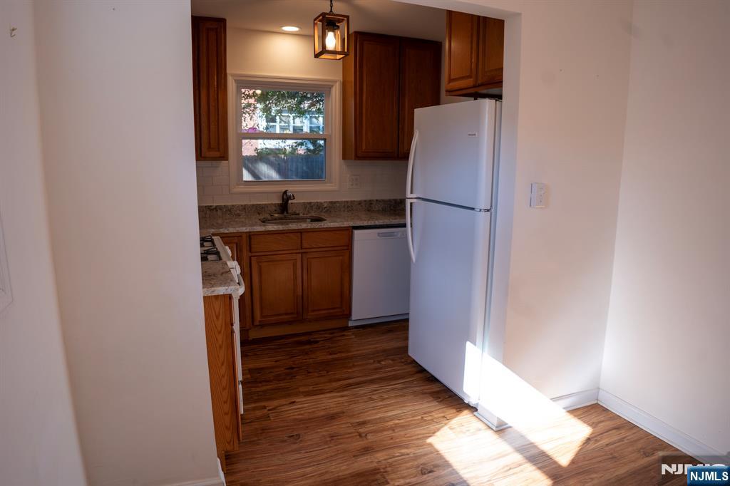 58 Elm Street Dumont, NJ 07628 - Photo 11 of 28 a kitchen with stainless steel appliances granite countertop a refrigerator and a sink