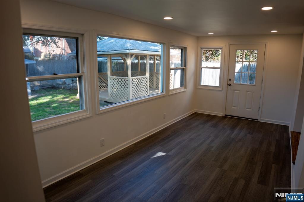 58 Elm Street Dumont, NJ 07628 - Photo 13 of 28 a view of empty room with wooden floor and fan
