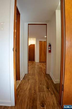 a view of hallway with wooden floor