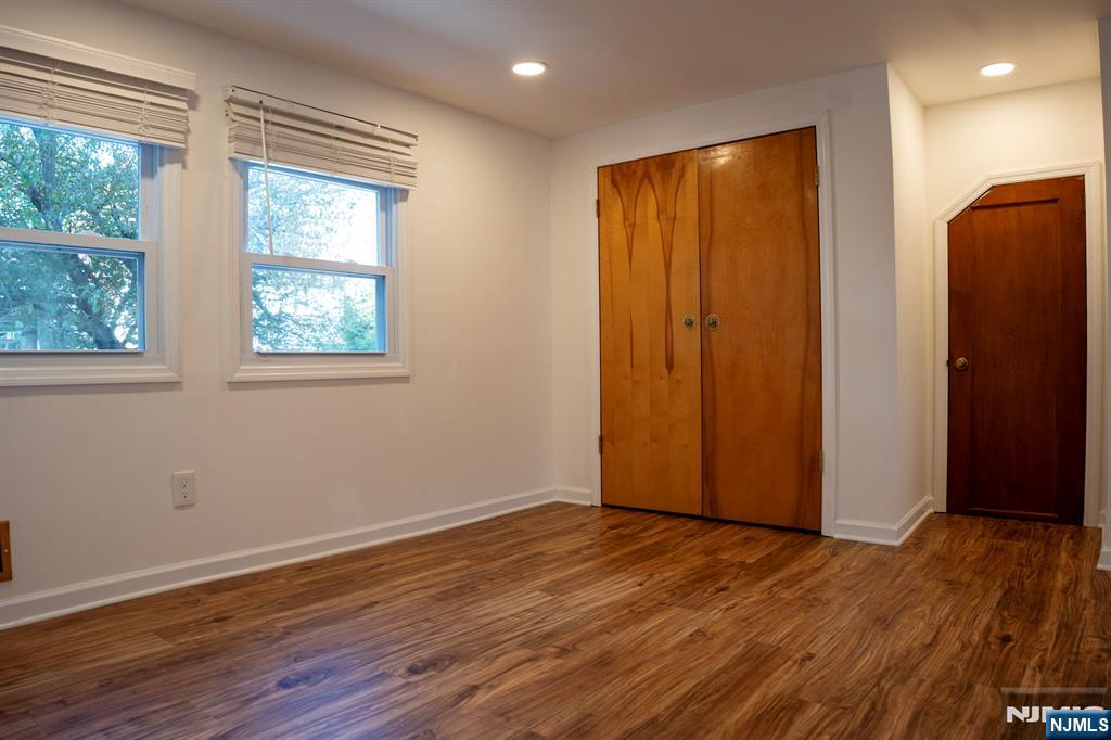 58 Elm Street Dumont, NJ 07628 - Photo 21 of 28 an empty room with wooden floor and a window
