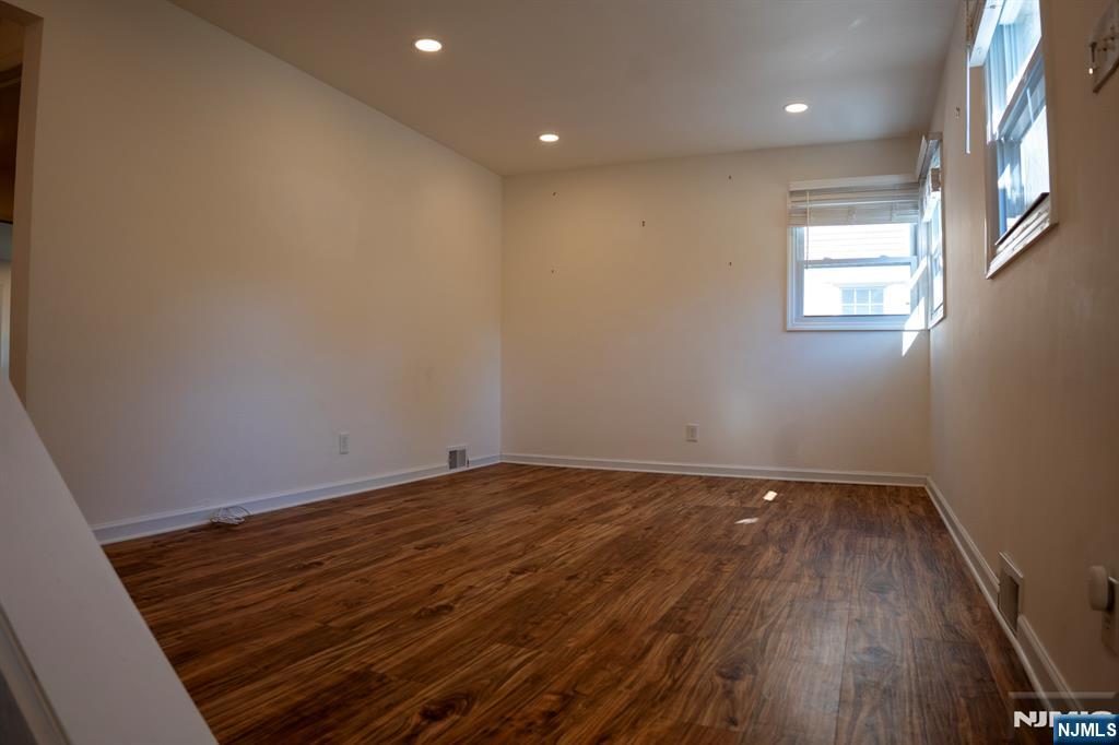 58 Elm Street Dumont, NJ 07628 - Photo 4 of 28 a view of an empty room with wooden floor and a window