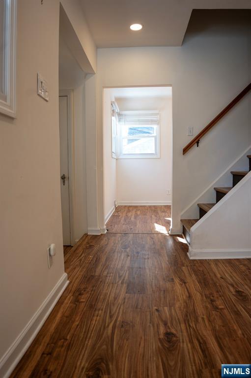 58 Elm Street Dumont, NJ 07628 - Photo 6 of 28 a view of an empty room with wooden floor and a window